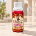 Roseoasis Oud Touch perfume oil 100g bottle on a cream daylight background