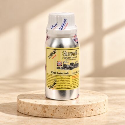 Surrati Oud Interlude perfume oil bottle on a pale travertine pedestal